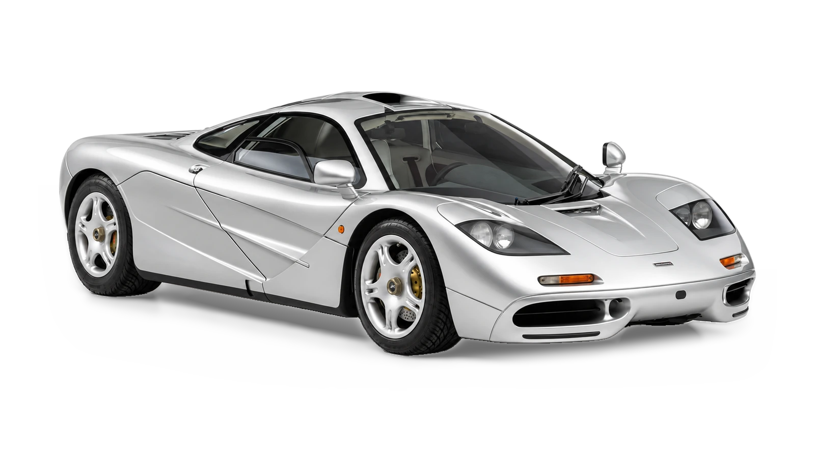AI-generated illustrative white-studio view of the McLaren F1 road car for the Atelier Grand Slam Collector Index